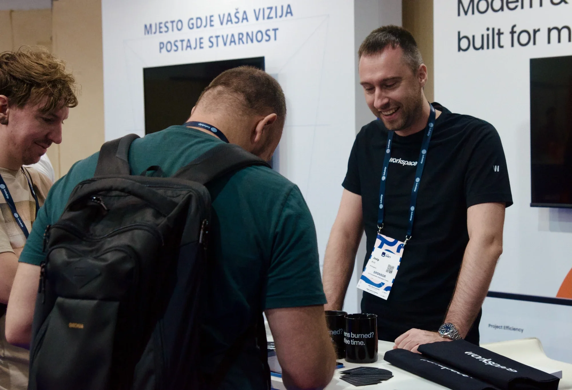 Josip Brčić talking with visitors at the Workspace booth at Infobip Shift 2026